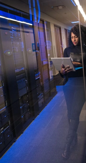 Woman working in a data center hallway