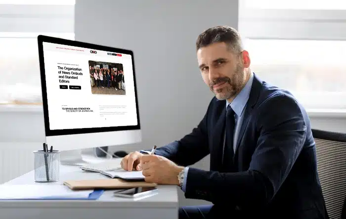 Office professional working at computer desk.